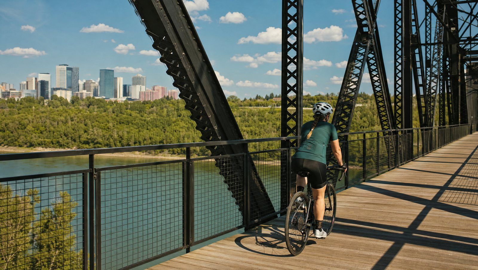Cycling across the bridge over the Edmonton river valley in summer